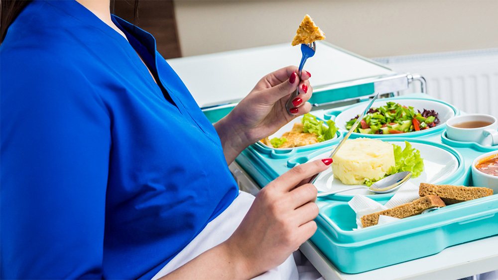 Patient eating a light hospital meal