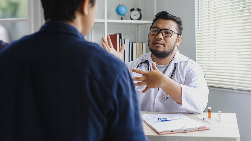 Surgeon consulting a patient about hernia treatment